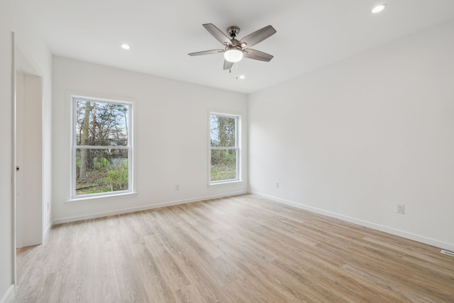 unfurnished room with light wood-type flooring and ceiling fan