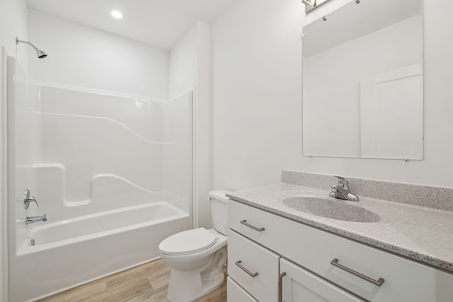 full bathroom featuring toilet, vanity, bathtub / shower combination, and hardwood / wood-style flooring