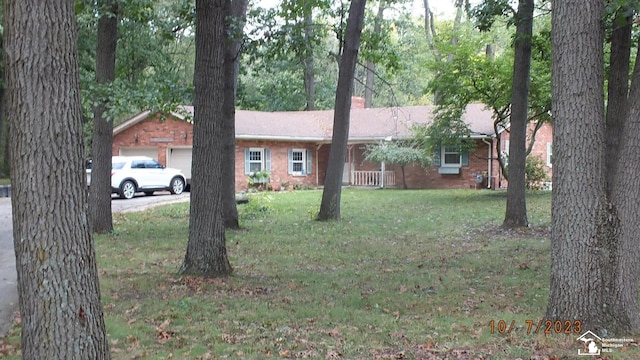 single story home featuring a garage and a front lawn