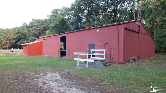 view of outbuilding with a yard