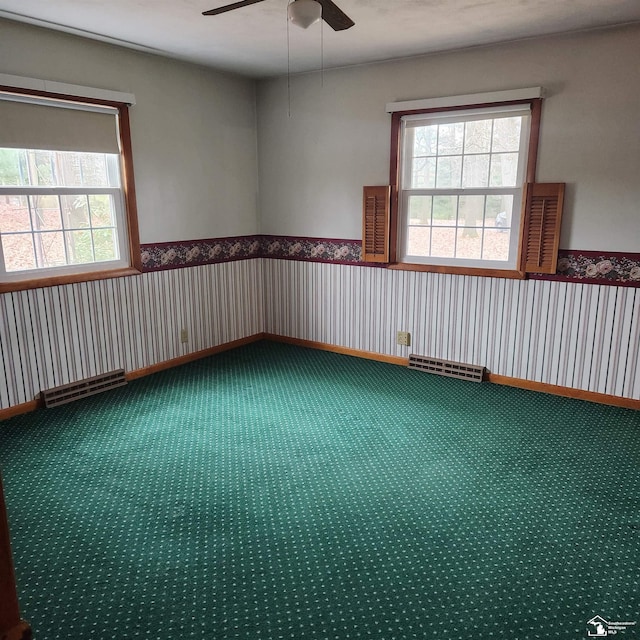 empty room featuring carpet floors and ceiling fan