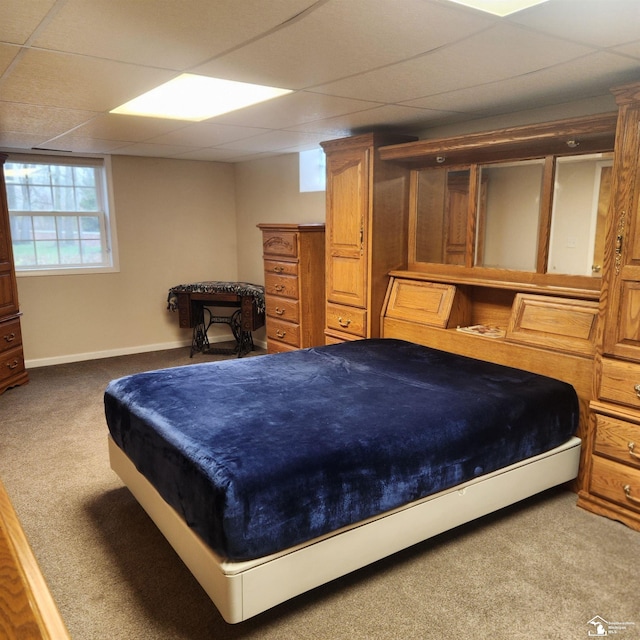 carpeted bedroom with a drop ceiling