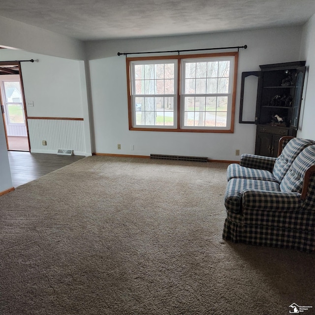 unfurnished living room with carpet and a textured ceiling