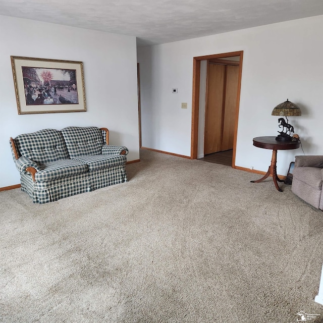 carpeted living room featuring a textured ceiling