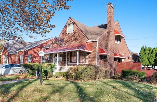 english style home with a front lawn