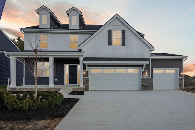 view of front of home with a porch and a garage