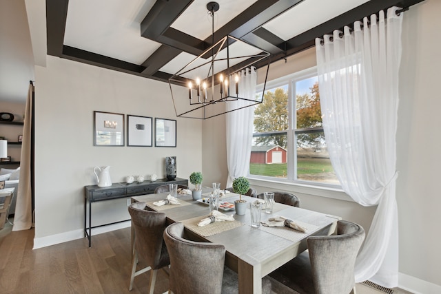 dining room with beamed ceiling, a healthy amount of sunlight, dark hardwood / wood-style floors, and an inviting chandelier