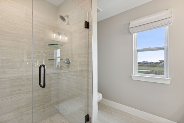 bathroom featuring an enclosed shower, tile patterned flooring, and toilet