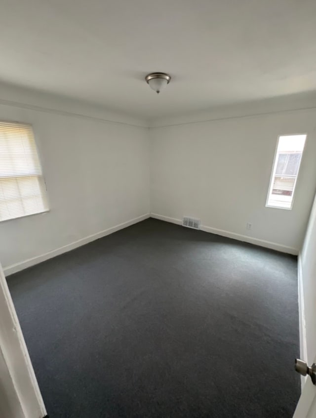 empty room with dark carpet