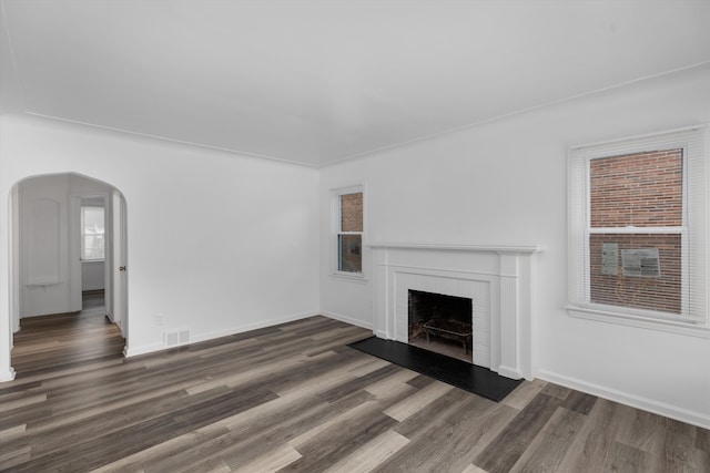 unfurnished living room featuring a fireplace and dark hardwood / wood-style flooring