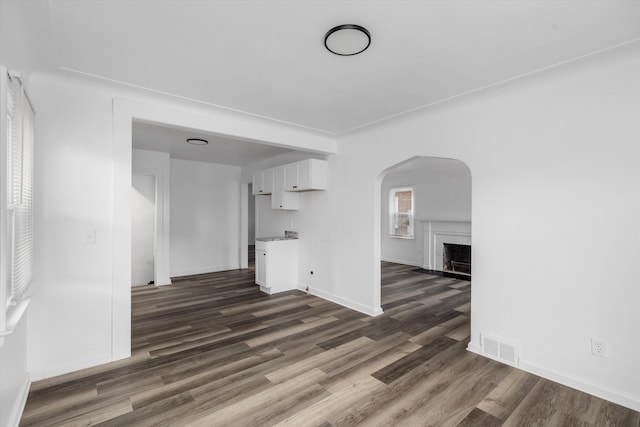 unfurnished living room featuring dark wood-type flooring