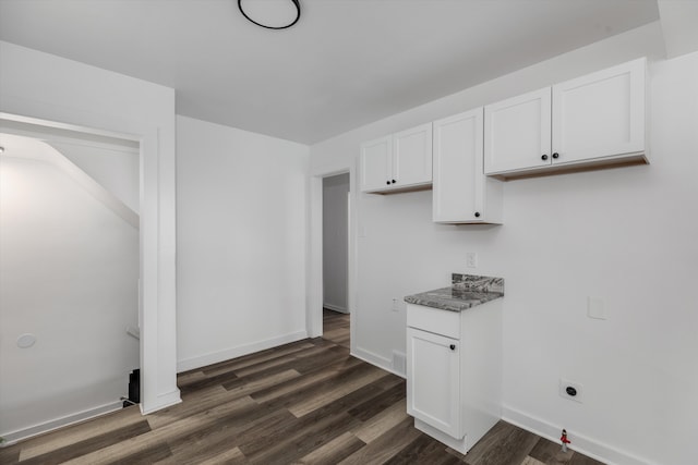 kitchen featuring white cabinetry and dark wood-type flooring