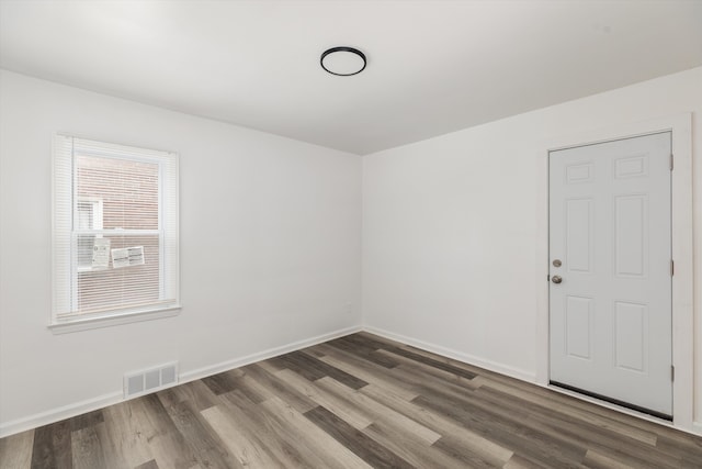 unfurnished room with dark hardwood / wood-style flooring