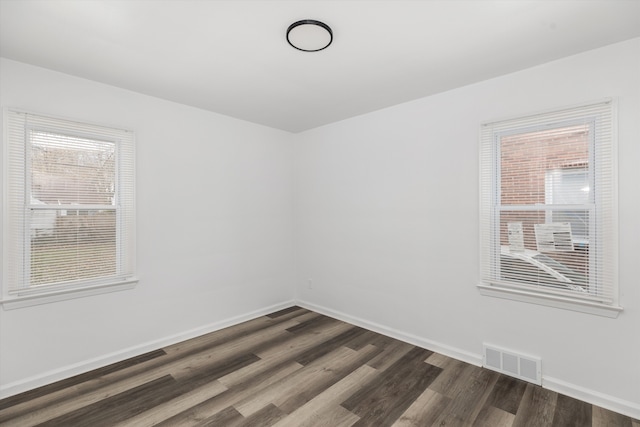 unfurnished room with dark hardwood / wood-style floors