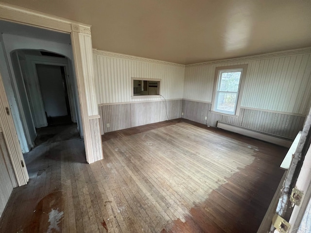 unfurnished living room featuring dark wood-type flooring and a baseboard radiator