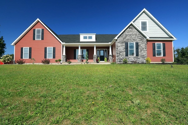 craftsman inspired home with a porch and a front yard