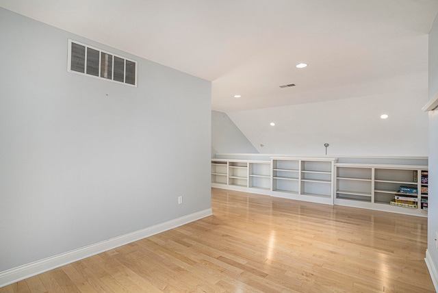 unfurnished living room featuring light hardwood / wood-style floors and lofted ceiling