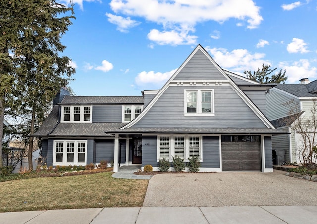 view of front of home with a front yard and a garage