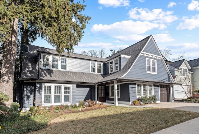 view of property featuring a garage and a front yard