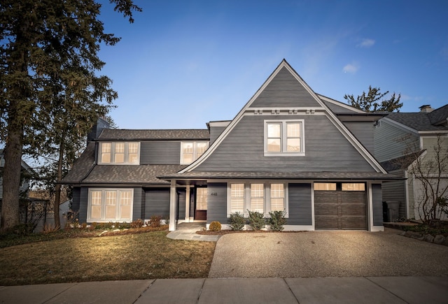 front of property with a front yard and a garage