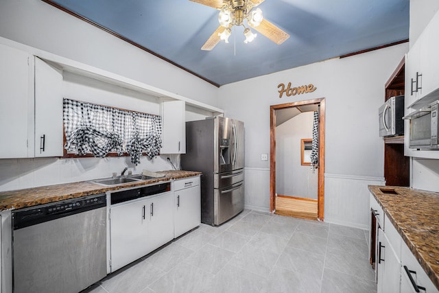 kitchen featuring ceiling fan, sink, stainless steel appliances, white cabinets, and ornamental molding