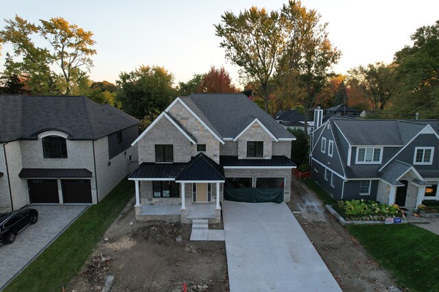 view of front of home featuring a porch and a garage