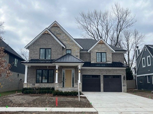 craftsman-style home featuring a garage and covered porch