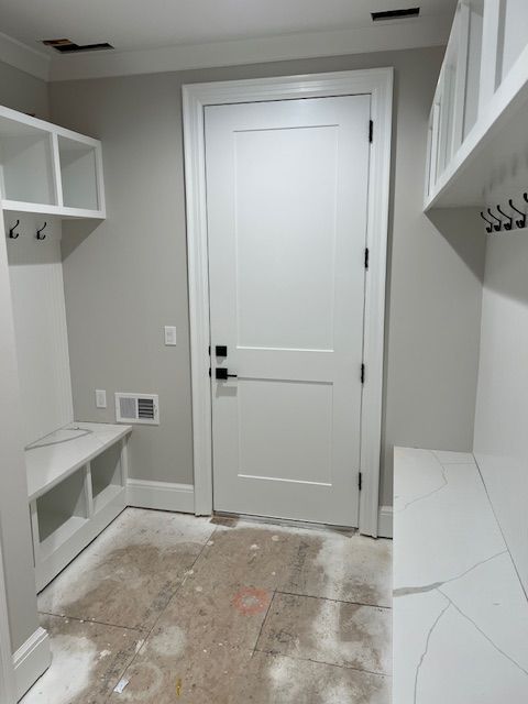 mudroom with baseboards and visible vents