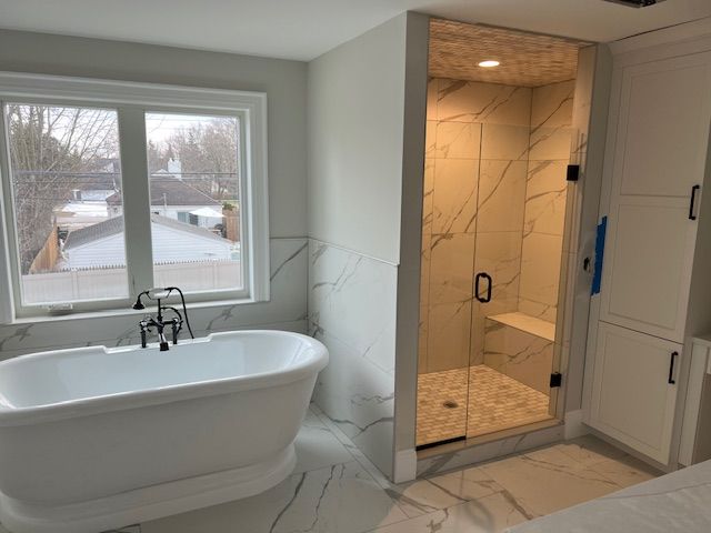 bathroom featuring plenty of natural light and shower with separate bathtub