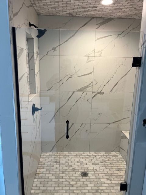 bathroom featuring a shower with shower door