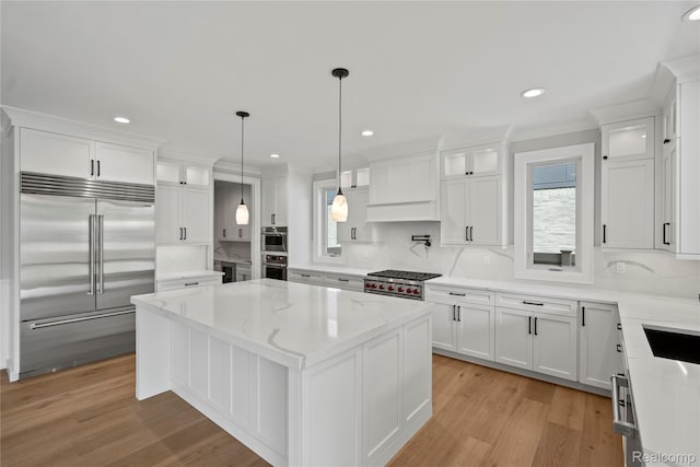 2182 Buckingham Ave, Birmingham, MI 48009 - kitchen featuring appliances with stainless steel finishes, a kitchen island, healthy amount of natural light, white cabinetry, and recessed lighting