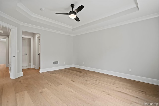 2182 Buckingham Ave, Birmingham, MI 48009 - spare room featuring a tray ceiling, a ceiling fan, ornamental molding, light wood-type flooring, and a smoke detector