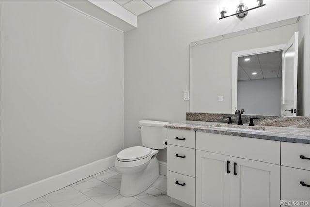 2182 Buckingham Ave, Birmingham, MI 48009 - bathroom featuring toilet, vanity, marble look tiles, baseboards, and recessed lighting