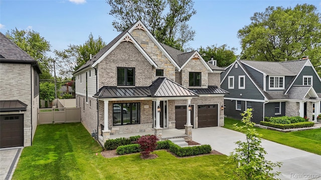 2182 Buckingham Ave, Birmingham, MI 48009 - view of front facade featuring driveway, a standing seam roof, a porch, a garage, and stone siding