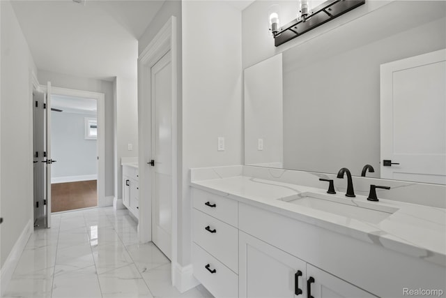 2182 Buckingham Ave, Birmingham, MI 48009 - bathroom with baseboards, marble finish flooring, and vanity