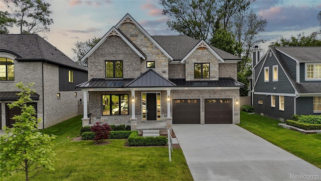 2182 Buckingham Ave, Birmingham, MI 48009 - view of front of property featuring a standing seam roof, driveway, an attached garage, and a front lawn
