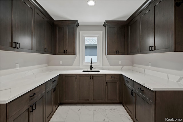 2182 Buckingham Ave, Birmingham, MI 48009 - kitchen featuring a sink, light marble finish flooring, light stone countertops, recessed lighting, and dark brown cabinetry
