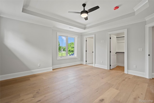 2182 Buckingham Ave, Birmingham, MI 48009 - unfurnished bedroom with a raised ceiling, light wood-type flooring, baseboards, crown molding, and a ceiling fan