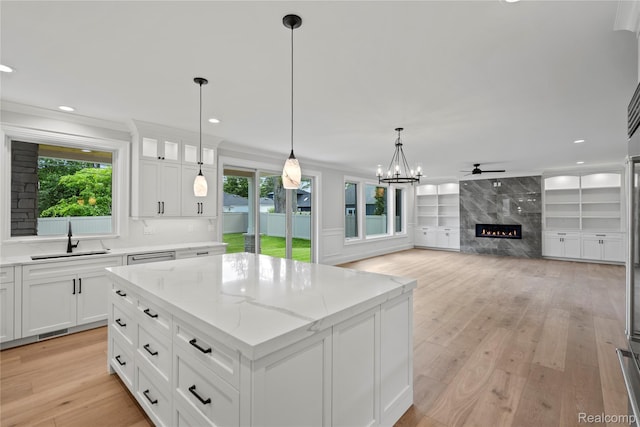 2182 Buckingham Ave, Birmingham, MI 48009 - kitchen featuring a sink, plenty of natural light, a premium fireplace, a center island, and recessed lighting