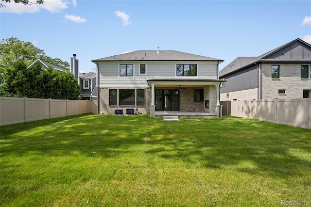 2182 Buckingham Ave, Birmingham, MI 48009 - rear view of house with a patio, brick siding, and central AC