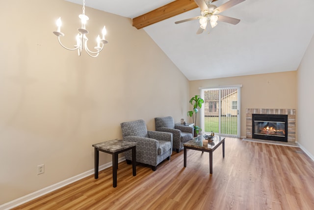 living room with beamed ceiling, ceiling fan with notable chandelier, light hardwood / wood-style floors, and high vaulted ceiling