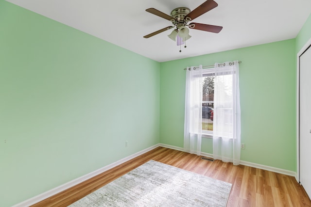 empty room featuring ceiling fan and light wood-type flooring