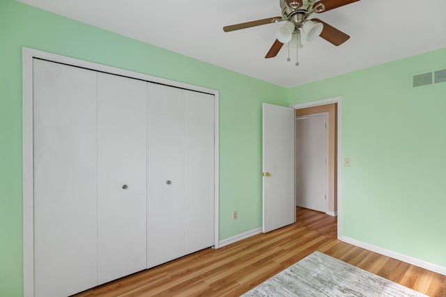 unfurnished bedroom featuring a closet, ceiling fan, and light hardwood / wood-style flooring