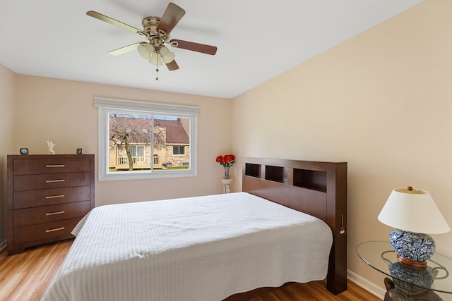 bedroom featuring light wood-type flooring and ceiling fan