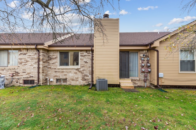 back of house featuring a lawn and central AC unit