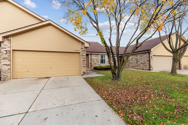 view of front of property with a garage and a front lawn