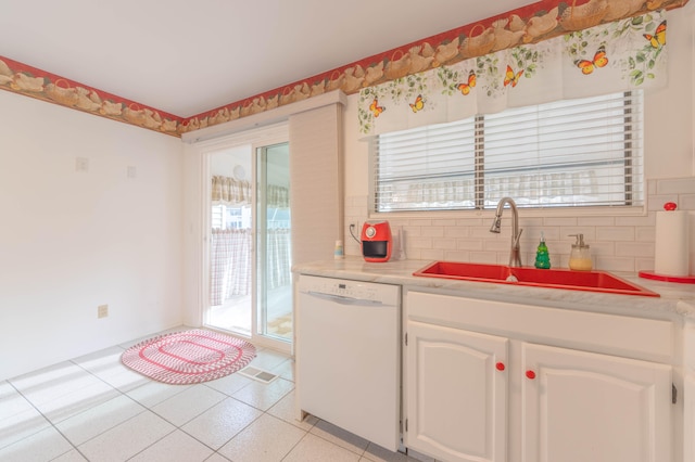 kitchen with white cabinetry, decorative backsplash, sink, and white dishwasher