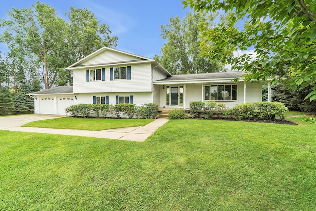 tri-level home featuring a garage and a front yard