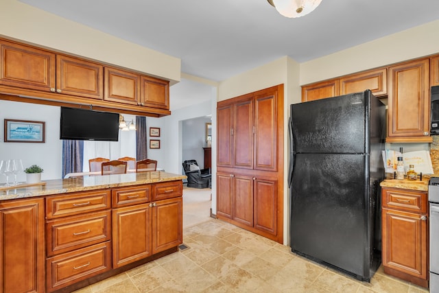 kitchen with black appliances and light stone counters