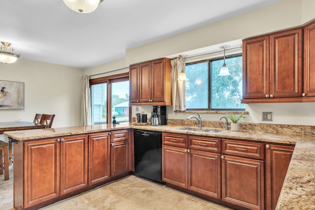 kitchen featuring kitchen peninsula, light stone counters, sink, decorative light fixtures, and black dishwasher